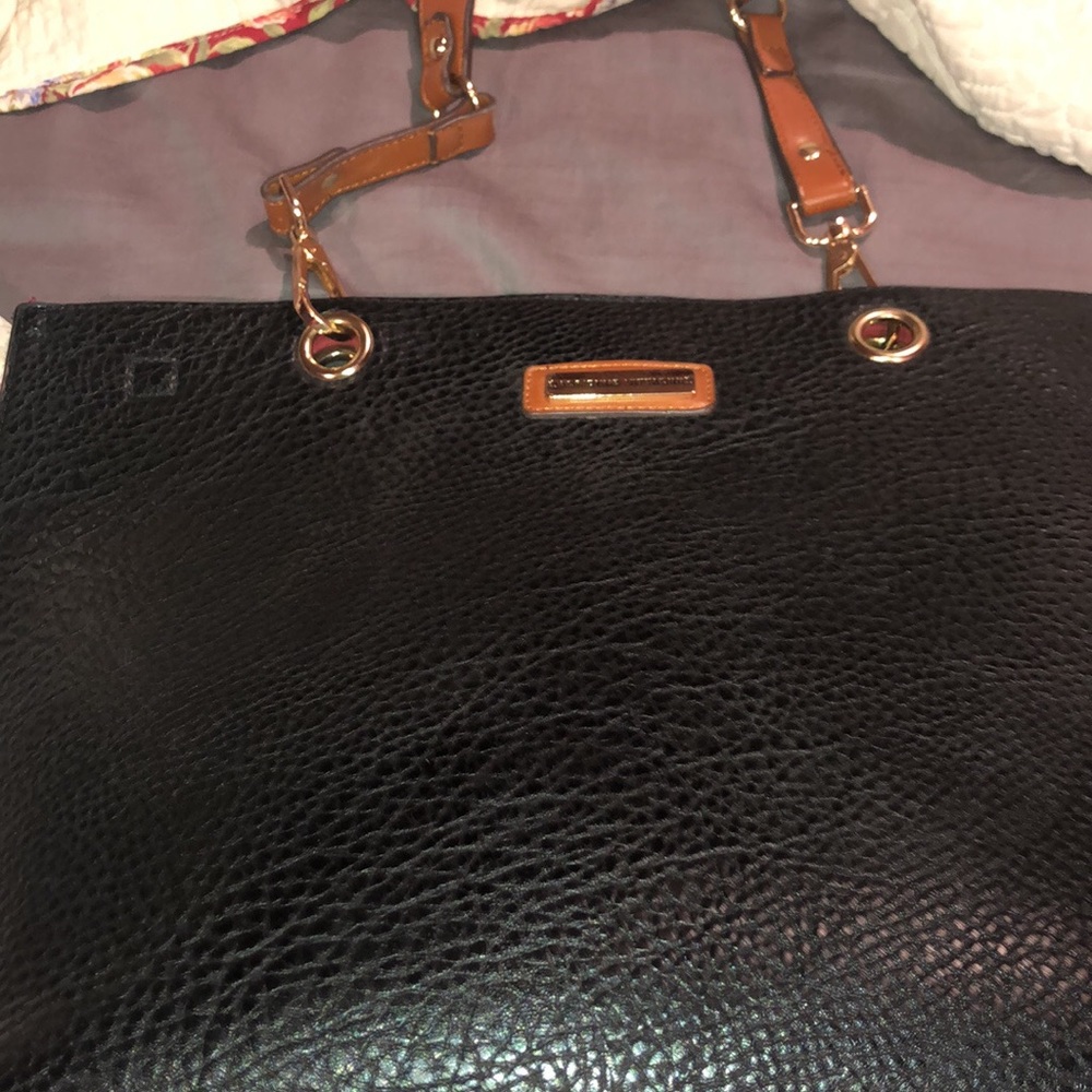 Black purse with a brown shoulder strap